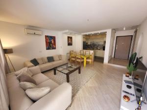 a living room with a couch and a table at Luxuary pool appartement in La Marsa