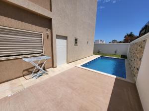 a swimming pool in the backyard of a house at Luxuary pool appartement in La Marsa