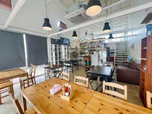 a restaurant with a wooden table and chairs and tables at 3199 Cafe' Latya & Bed in Ban Lum Makok