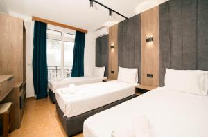 a hotel room with two beds and a window at Hotel Dajti in Ulcinj