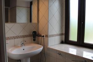 a bathroom with a sink and a phone on the wall at B&B La Taverna in Campodimele +22 photos
