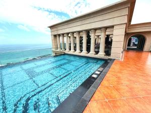 a swimming pool with a view of the ocean at Diamond Suite The Hill Phu Quoc in Phú Quốc