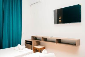 a room with two beds and a tv on the wall at Hotel Dajti in Ulcinj +46 photos