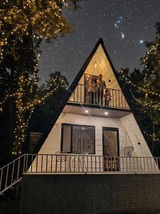 two people on the balcony of a house at night at The jungle tales in Bhīm Tāl
