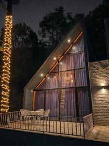 a building with two chairs on a balcony at night at The jungle tales in Bhīm Tāl