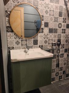a bathroom with a sink and a mirror at The jungle tales in Bhīm Tāl