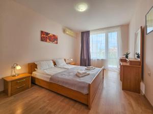 a bedroom with a bed and a large window at Marina and Panorama Apartments in Sveti Vlas +37 photos