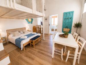 a bedroom with a bed and a table in a room at Casa Lebirann in Bacoli