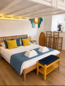a bedroom with a large bed with yellow and blue pillows at Casa Lebirann in Bacoli