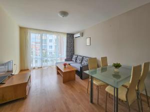 a living room with a couch and a table at Marina and Panorama Apartments in Sveti Vlas