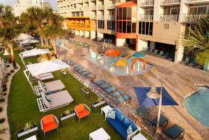 an overhead view of a pool with chairs and umbrellas at Hampton Inn & Suites Myrtle Beach Oceanfront in Myrtle Beach