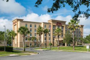 a rendering of a hotel with palm trees in front at Hampton Inn & Suites - DeLand in De Land