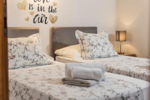 a bedroom with two beds and a sign that says you is in the cut at Villa Žnjan in Split