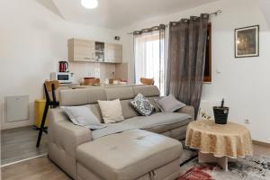 a living room with a couch and a table at Villa Žnjan in Split