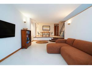a living room with a couch and a flat screen tv at GALIHOST - Casa Chouba, frente a la playa in Sanxenxo