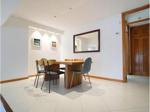 a dining room with a wooden table and chairs at GALIHOST - Casa Chouba, frente a la playa in Sanxenxo