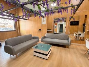 a living room with two couches and a coffee table at As Baladas Hostel in Barro