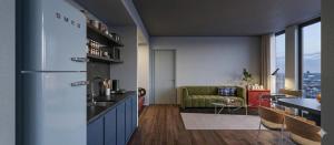 a kitchen with a refrigerator and a living room at Len Hotel in Da Lat