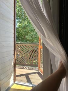 a person looking out of a window at a porch at Білий птаха in Svityazʼ