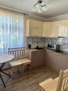 a kitchen and dining room with a table and chairs at Білий птаха in Svityazʼ