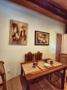 a dining room table and chairs with a wooden table at Border Bridge House in Tui