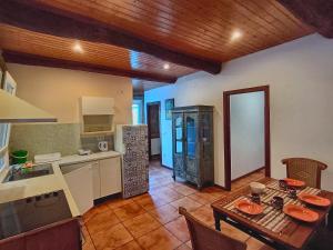 a kitchen and dining room with a table and a counter at Border Bridge House in Tui +10 photos