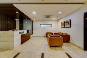 a lobby with chairs and a counter in a building at RG Suites - Royapettah in Chennai