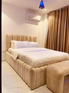 a large bed in a room with a window at Eminoky Apartment in Lagos +5 photos