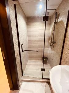 a bathroom with a shower and a sink at Eminoky Apartment in Lagos