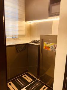 a small kitchen with a stove and a refrigerator at Eminoky Apartment in Lagos