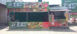 a store with signs on the side of a building at Eighty eight restaurant and cafe in Muzaffarnagar