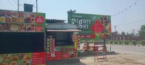 a food stand with signs on the side of a road at Eighty eight restaurant and cafe in Muzaffarnagar