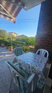 a table and chairs on a patio with a table at House Peri in Trogir