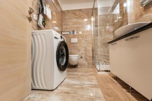 a bathroom with a washing machine and a sink at Villa Žnjan in Split +30 photos