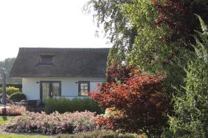 a white house with a bunch of flowers at Aan de Amstel in De Hoef +14 photos