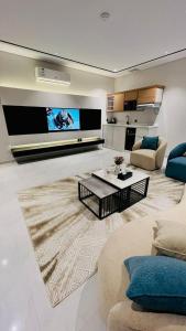 a large living room with a couch and a table at Bright Moon in Al-ʿUla +11 photos