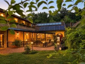 a house with solar panels on the side of it at Rooms Villa Iva in Ilok