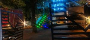 a gate in a street at night with lights at Laya Neem Resort in Dambulla