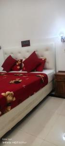 a bedroom with a bed with red pillows at Laya Neem Resort in Dambulla