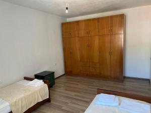 a bedroom with two beds and a cabinet at LakeView Pogradec in Pogradec