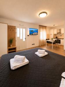 a large bedroom with two beds and a table at Apartments & Rooms Prižmić in Podstrana