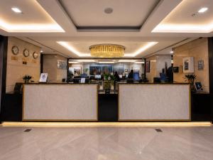 a lobby with three blank screens in front at Al Kiswah Towers Hotel in Mecca +34 photos