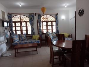 a living room with a couch and a table at Nelion Villas in Mambrui