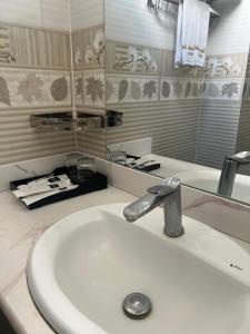 a bathroom sink with a faucet and a mirror at Thach An Hotel in Ðông Khê +39 photos