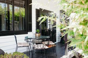 a patio with a table and chairs on a house at Ebony & Ivory Villa in Nelson Bay +13 photos