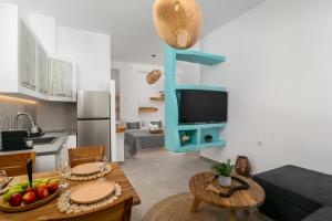a kitchen and living room with a table and a television at Villa Balliu Panorama in Tripiti