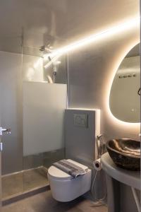a bathroom with a toilet and a sink at Villa Balliu Panorama in Tripiti +32 photos