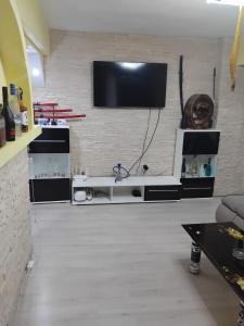 a living room with a flat screen tv on a wall at D&ATurism in Băile Govora