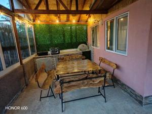 a wooden table and chairs on a patio at Trpejca Аpartment Nikola in Trpejca