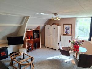 a living room with a table and a cabinet at Hof van Eden in Ophemert +28 photos